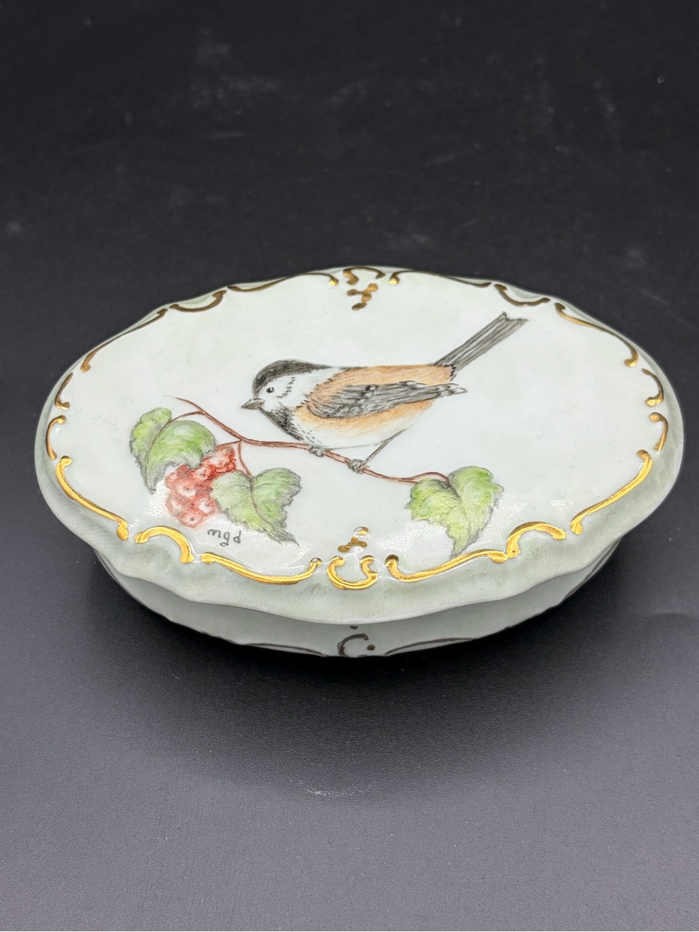 Hand-painted porcelain or ceramic trinket box featuring a small bird